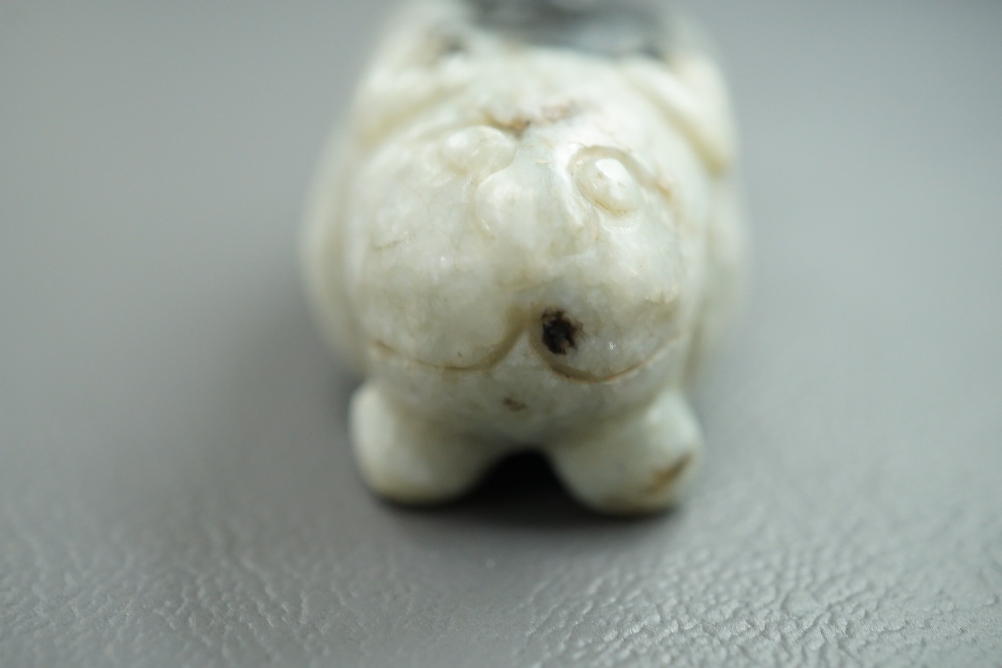 A Chinese white and black jade figure of a recumbent tiger, Song dynasty